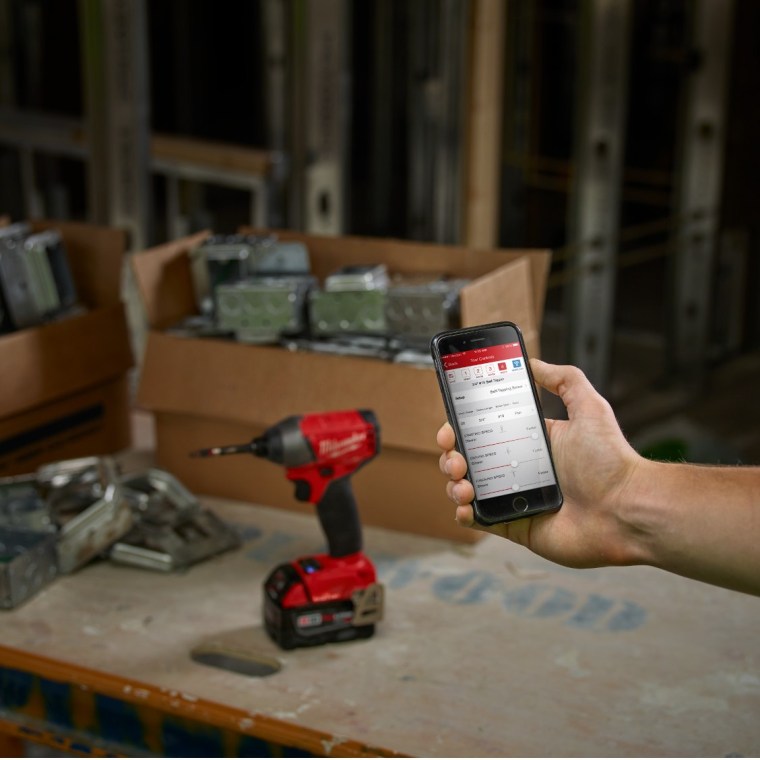 Milwaukee One-Key enabled drill and phone showing One-Key app